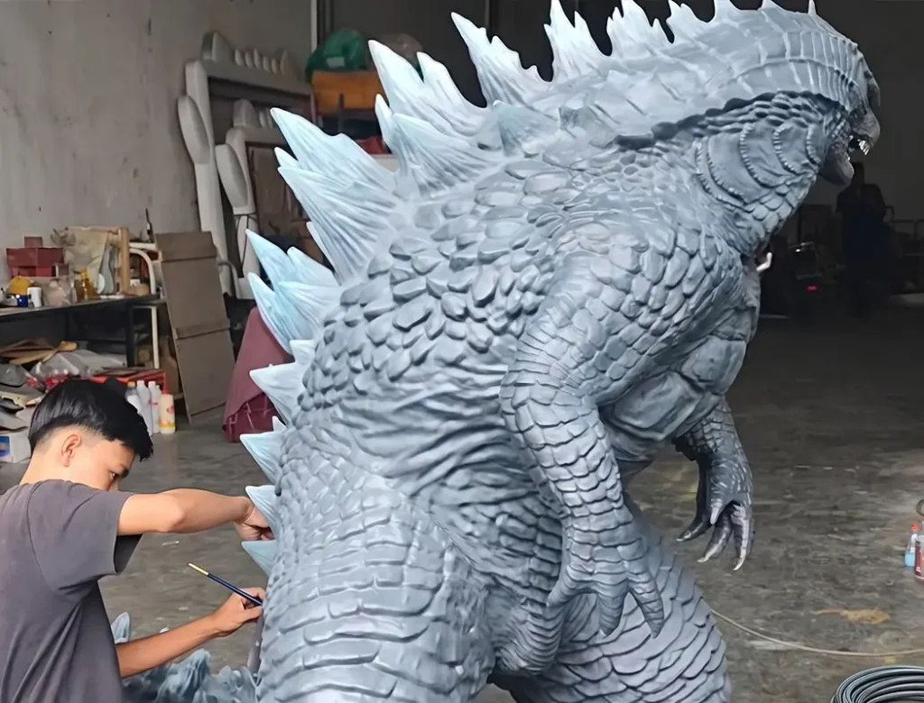 our worker is painting the 3d print godzilla sculpture.