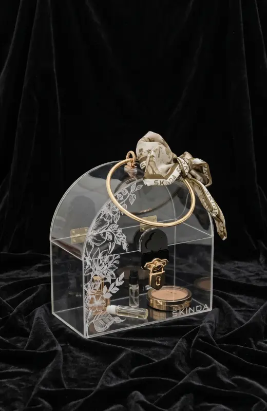 Skinda Acrylic Box acrylic box made of clear acrylic 2mm and comes with gold plated metal handle and lock. Also include UV printing on the front of box. Also include a custom scarf for aesthetic.